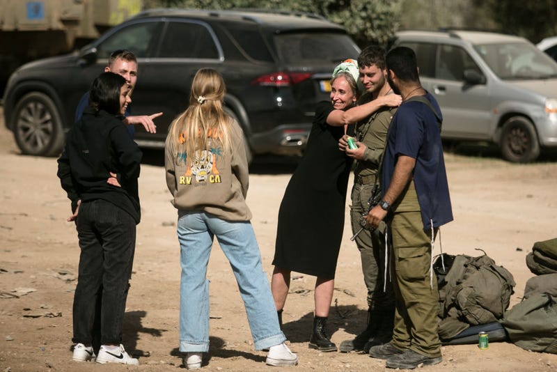 An Israeli soldier who recently exited the Gaza Strip meets his family on November 24, 2023 near the Gaza border in Israel. A total of 50 hostages currently held by Hamas are to be released during a four-day truce with Israel, the first such pause in fighting since Oct. 7, when Hamas launched its surprise attack and Israel responded with a vast military offensive to destroy the militant group that governs Gaza. Under the deal, 150 Palestinian prisoners are also to be released from Israel, and more humanitarian aid will be admitted at the Gaza-Egypt border crossing. (Photo by Amir Levy/Getty Images)