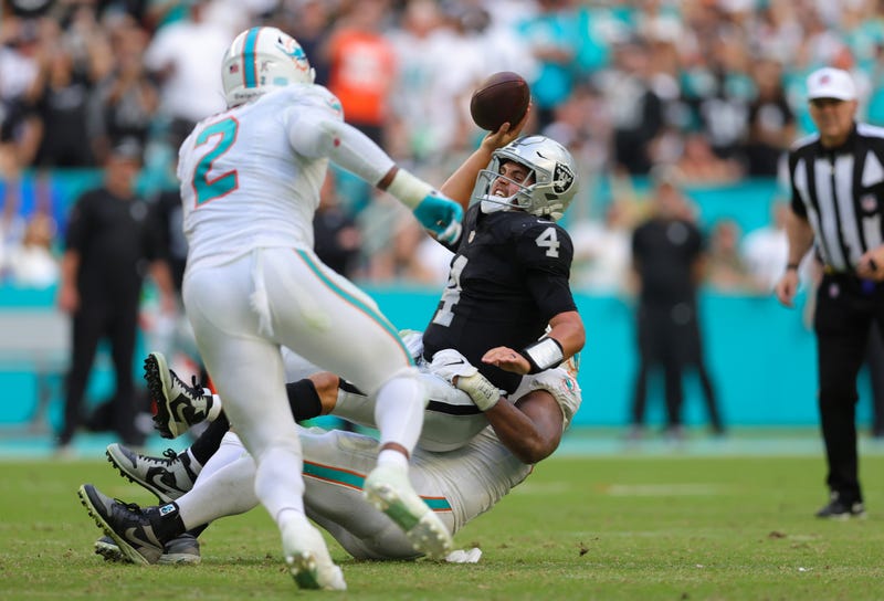 : Christian Wilkins #94 of the Miami Dolphins tackles Aidan O'Connell #4 of the Las Vegas Raiders during the fourth quarter at Hard Rock Stadium on November 19, 2023 in Miami Gardens, Florida.