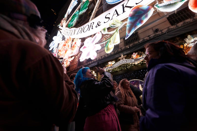 People take photos as Saks Fifth Avenue unveils its 2023 holiday windows on Nov. 20, 2023 in New York City.