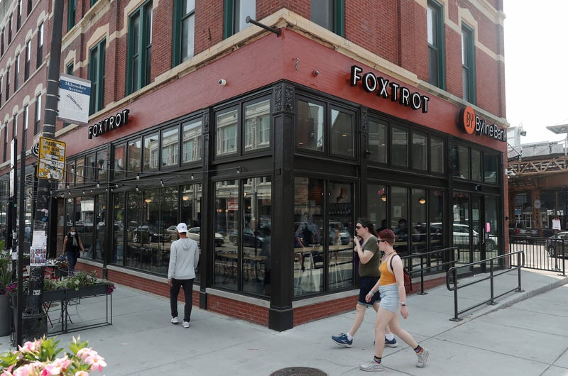 People walk past a Foxtrot grocery store located at 1576 N. Milwaukee Ave. The grocery chain abruptly closed all of its stores in April 2024, but now it appears that some of its locations will reopen.