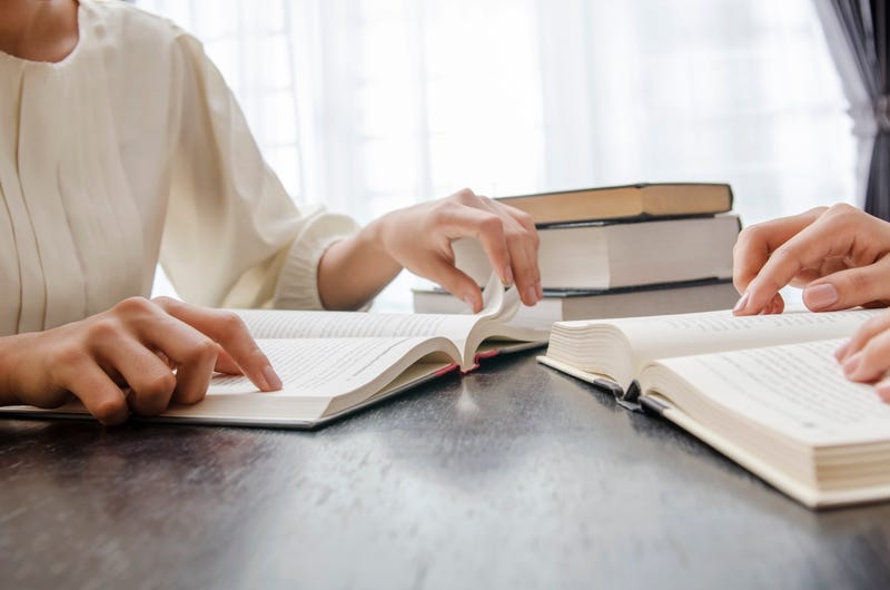 Students reading a textbook