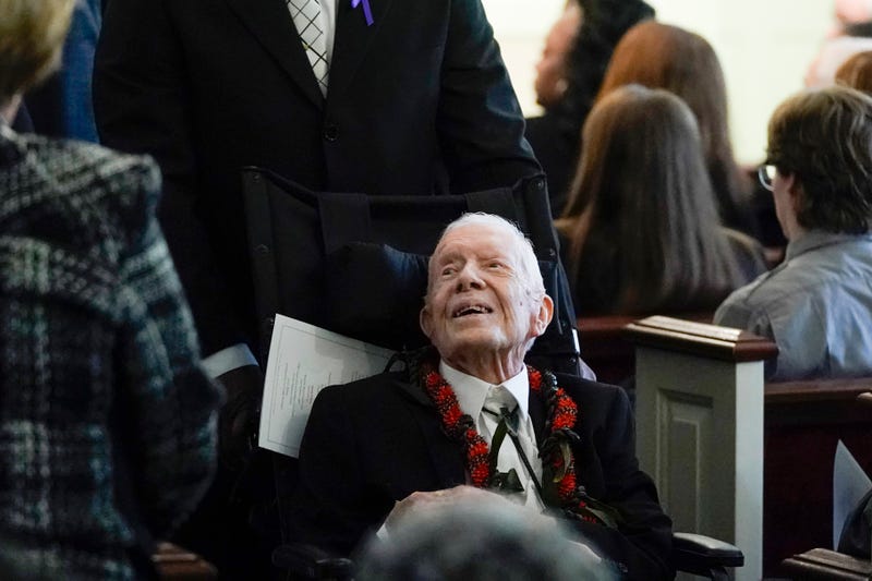 Former US President Jimmy Carter departs a funeral service for former US First Lady Rosalynn Carter, at Maranatha Baptist Church in Plains, Georgia, on November 29, 2023