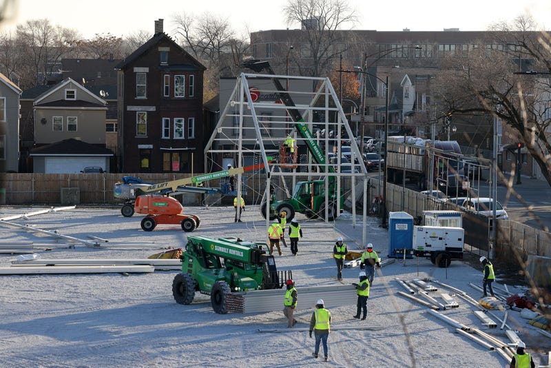 Workers erect a tent frame as they start building Chicago's first government-run tent encampment for migrants in the Brighton Park neighborhood on Wednesday, Nov. 29, 2023.