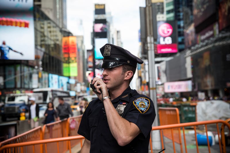 A New York Police Department (NYPD) officer speaks on his radio in Times Square in New York City. 