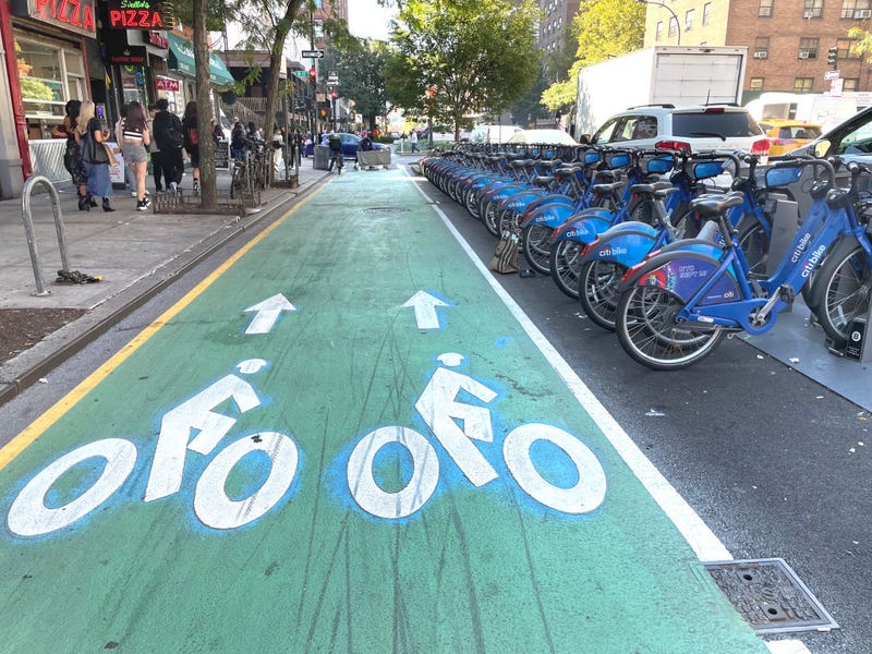 Green lane designated for bicycle travel created to separate vehicle traffic and provide safe cycling on New York City streets.