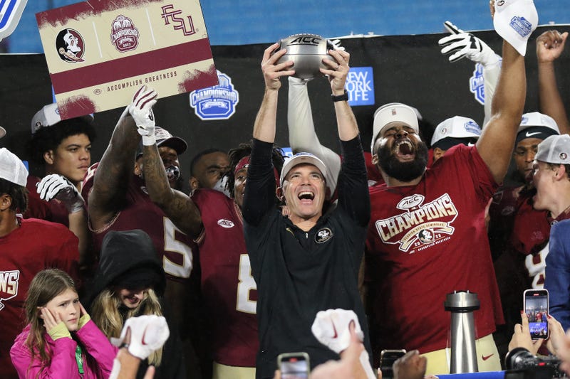 Florida State Seminoles Head Coach Mike Norvell holds up the trophy during the ACC Football Championship Game between the Louisville Cardinals and the Florida State Seminoles on Dec. 2, 2023, at Bank of America Stadium.