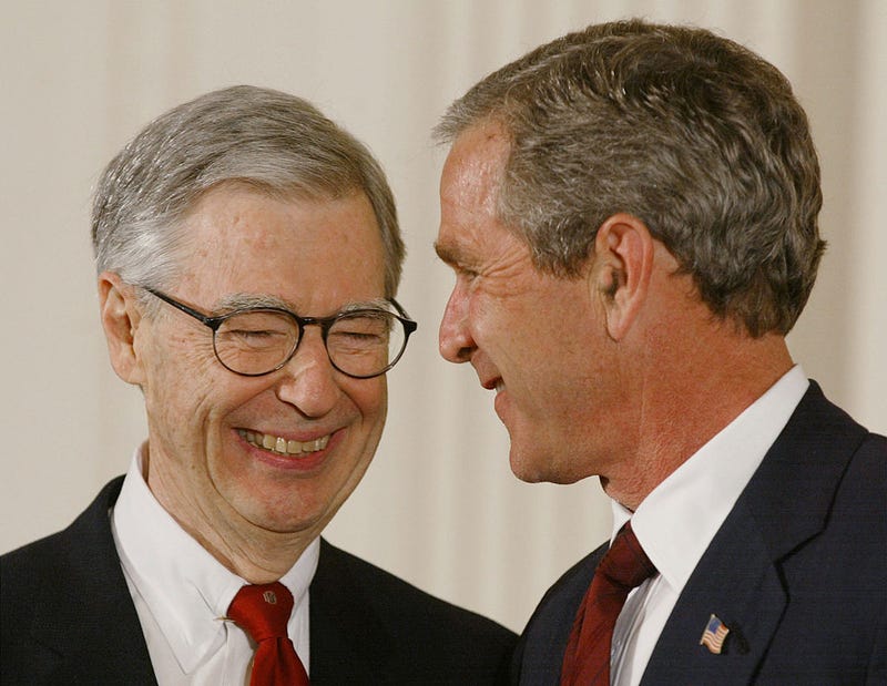 President George W. Bush presents Fred Rogers (L) with the Presidential Medal of Freedom Award during a ceremony July 9, 2002 at the White House in Washington, DC.