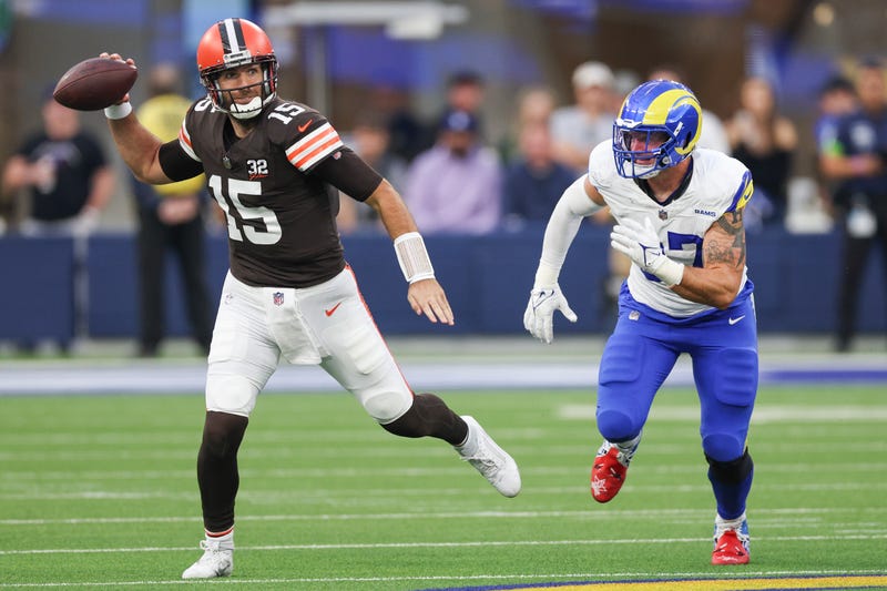 Joe Flacco #15 of the Cleveland Browns throws a pass while being chased by Michael Hoecht #97 of the Los Angeles Rams in the third quarter at SoFi Stadium on December 03, 2023 in Inglewood, California. 