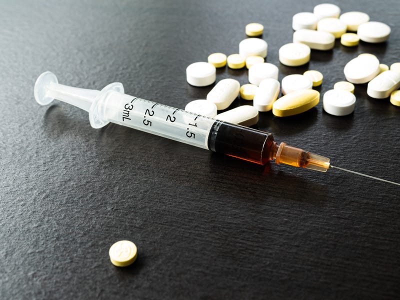 Drug syringe and pills