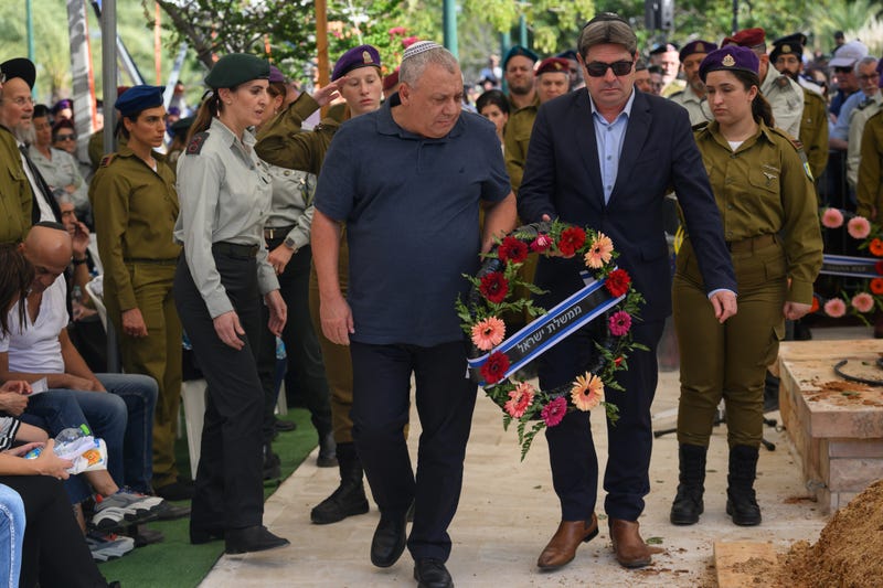 Lt. Gen. (Res.) Gadi Eizenkot (L), Minister of Knesset and former IDF Chief of Staff, and Ofir Akunis (R), then-Minister of Innovation, Science and Technology of Israel, lay a wreath at the grave of Col. Asaf Hamami, commander of Gaza Division's Southern Brigade, during his funeral at the Kiryat Shaul cemetery on December 04, 2023 in Tel Aviv, Israel. The Israel Defense Forces announced the death of Col. Hamami, who was initially believed to have been kidnapped during Hamas's Oct. 7 attack. However, it was later determined he was killed during the initial attack while defending Kibbutz Nirim.