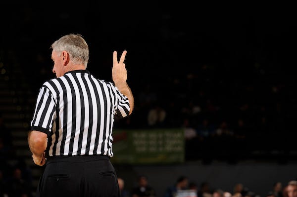 Basketball referee making hand sign