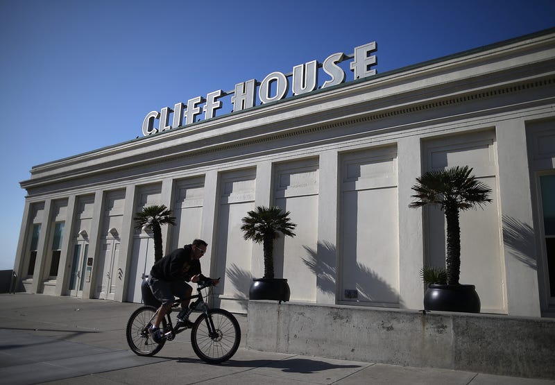 A cyclist rides by the Cliff House restaurant on October 10, 2013 in San Francisco, California. 