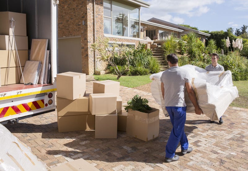 People unloading items off a moving truck