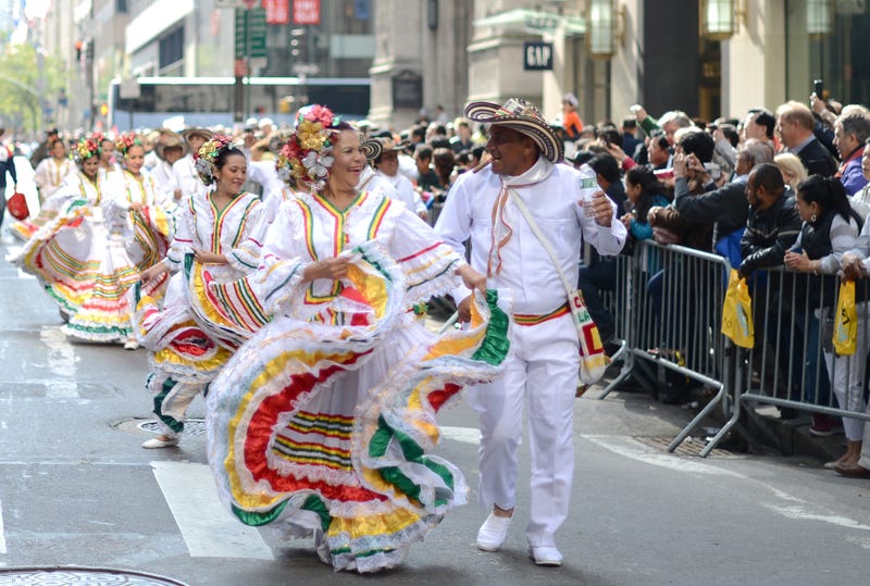 Dancers in colorful costumes pass on the Fifth Avenue in Manhattan, New York City, USA, during the Hispanic Day parade.