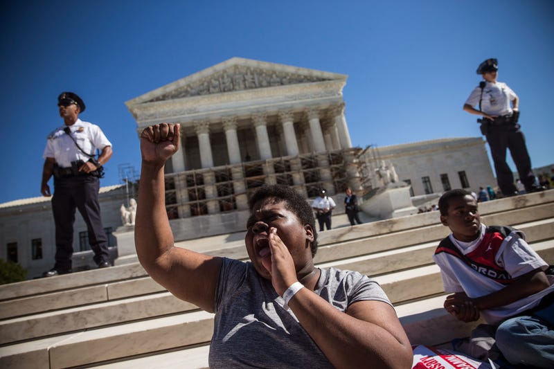 WASHINGTON, DC - OCTOBER 15: A woman protests in support of affirmative action, outside the Supreme Court during the hearing of "Schuette v. Coalition to Defend Affirmative Action" on October 15, 2013 in Washington, DC. The case revolves around affirmative action and whether or not states have the right to ban schools from using race as a consideration in school admissions.