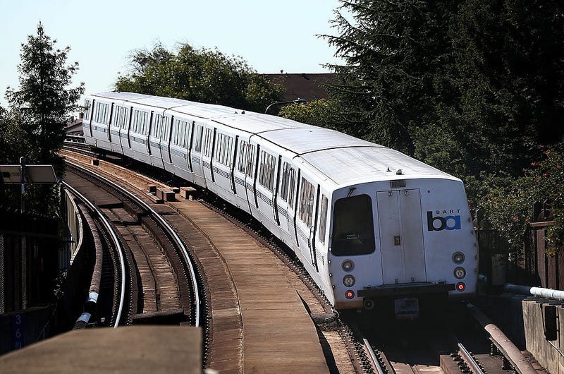 A Bay Area Rapid Transit (BART) train emerges from a tunnel.
