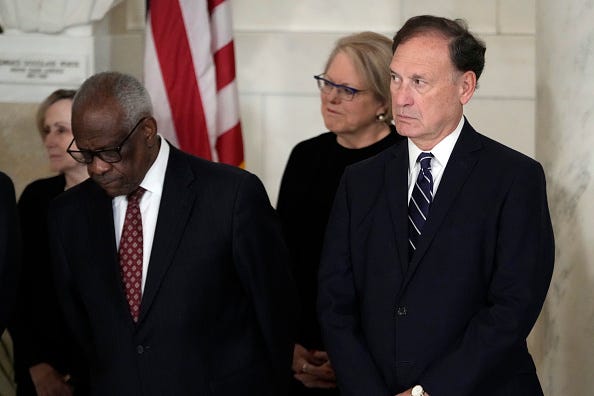 Supreme Court Justice Clarence Thomas and Justice Samuel Alito attend a private ceremony for retired Supreme Court Justice Sandra Day O'Connor before public repose in the Great Hall at the Supreme Court on December 18, 2023 in Washington, DC.