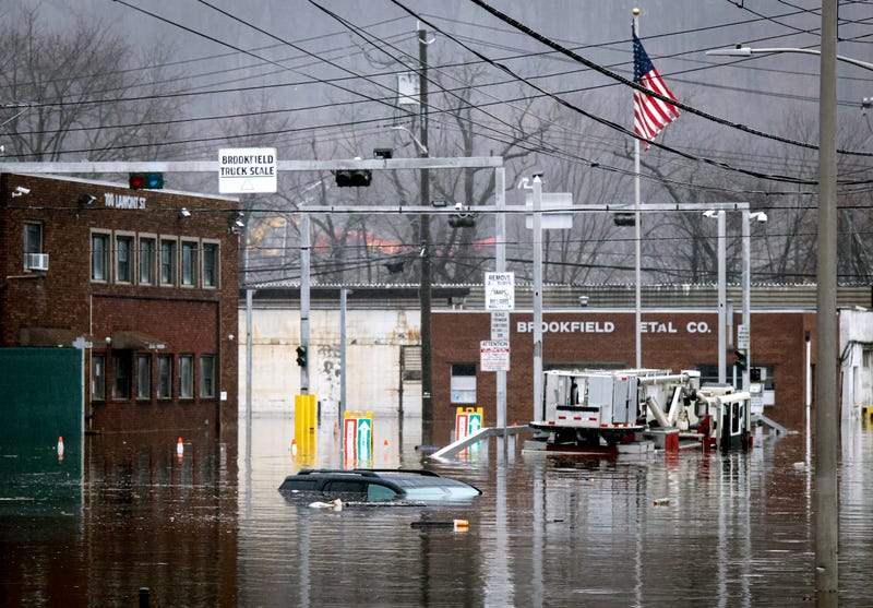 A car and a fire truck are submerged in flood water on Lamont Street in Elmsford, New York, on Dec. 18, 2023
