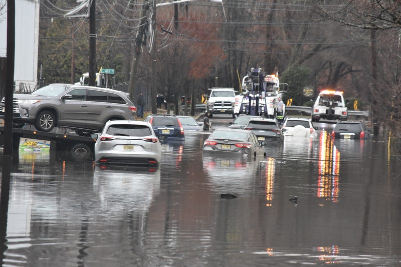 Vehicles are removed from floodwater in Paterson on Dec. 18, 2023