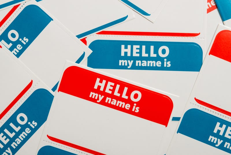 A stack of blue and red "Hello, my name is" name tags or badges