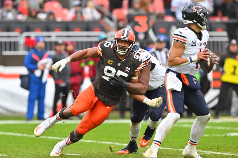 Myles Garrett #95 of the Cleveland Browns looks to tackle Justin Fields #1 of the Chicago Bears during the third quarter at Cleveland Browns Stadium on December 17, 2023 in Cleveland, Ohio. 