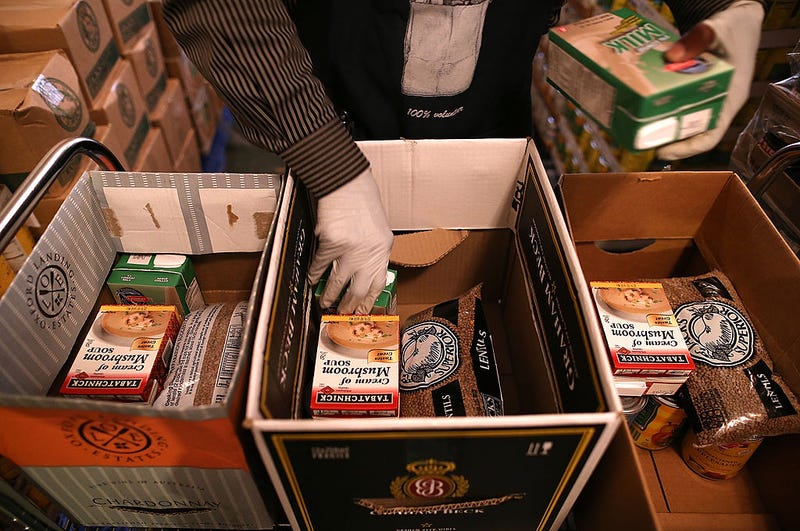 Emergency Food Bank volunteer Abdul Olorode packs boxes with food to be handed out to needy people