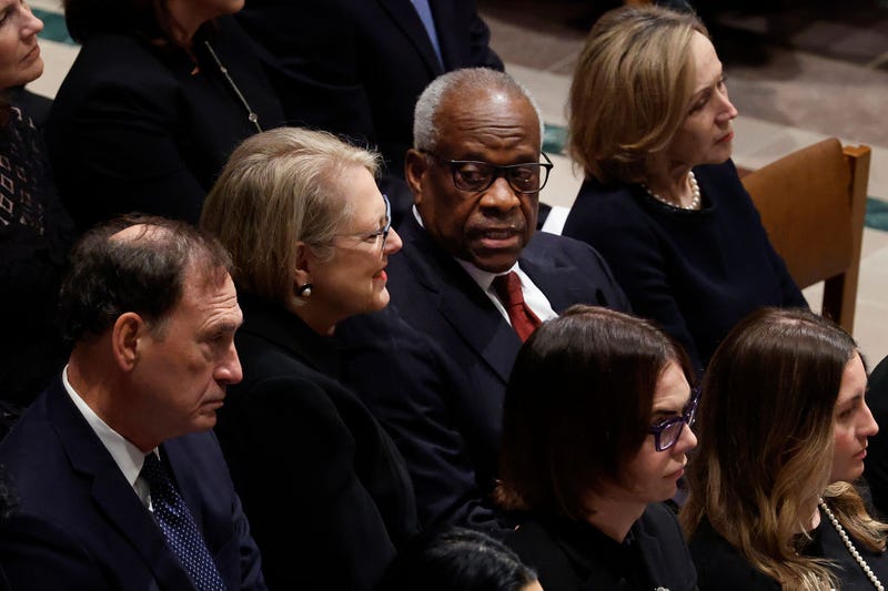 Justice Clarence Thomas (2nd R) talks with his wife Virginia Thomas as they and Justice Samuel Alito, Jr. (L) attend the funeral service for late retired Supreme Court Justice Sandra Day O'Connor at Washington National Cathedral on December 19, 2023 in Washington, DC.