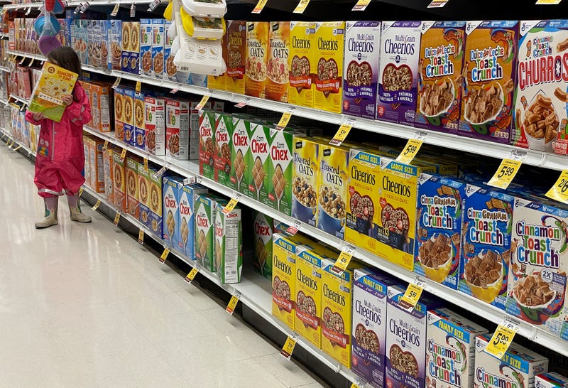 Boxes of General Mills cereal are displayed on a grocery store shelf