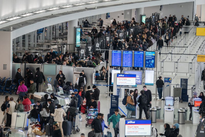 Travelers line up to enter a security checkpoint at John F. Kennedy International Airport (JFK) on December 23, 2023 in New York, New York. 