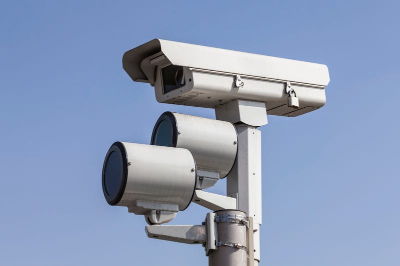 Traffic intersection signal surveillance camera with lights.