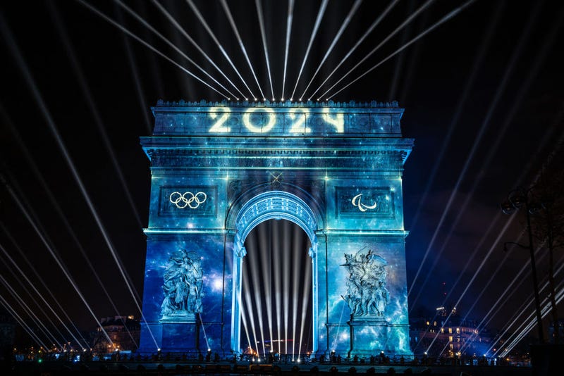 This photograph taken in Paris, on December 31, 2023, shows the Arc de Triomphe illuminated with Olympic rings for the New Year celebrations.