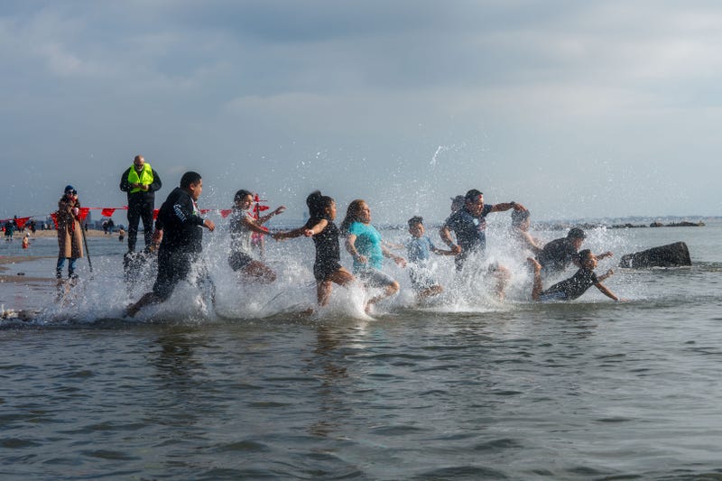 People participate in the 121st annual Polar Bear Plunge in Coney Island on January 1, 2024 in New York City.