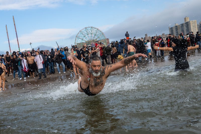 People participate in the 121st annual Polar Bear Plunge in Coney Island on January 1, 2024 in New York City. The New Year's Day event expects some 4,000 swimmers and 20,000 onlookers this year. 