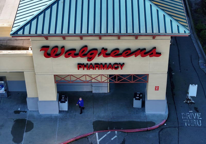 In an aerial view, a customer leaves a Walgreens store on January 04, 2024 in San Pablo, California. Shares of Walgreens stock fell sharply after the company reported better-than-expected first quarter earnings but plans to cut its quarterly dividend nearly in half. (Photo by Justin Sullivan/Getty Images)