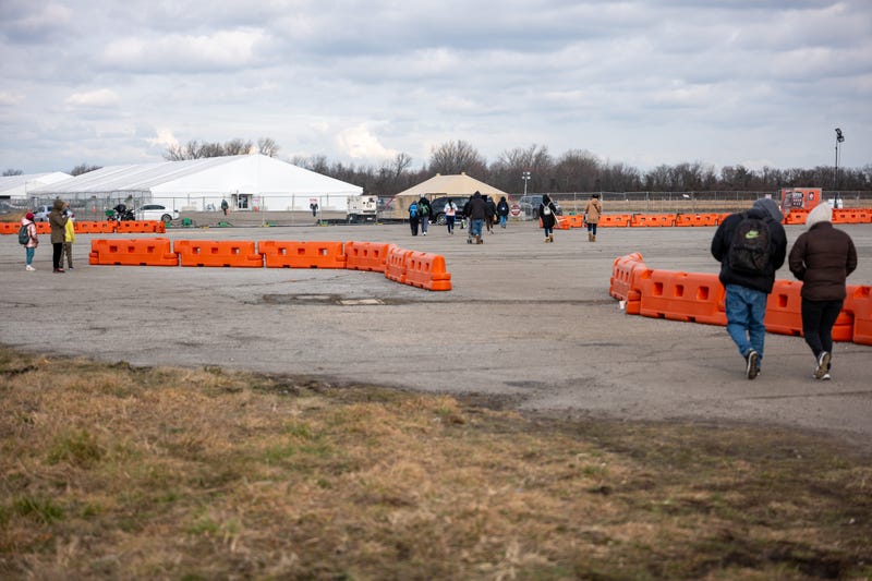 Recently arrived migrants walk from their temporary tent shelters at Floyd Bennett Field on Jan. 4, 2024