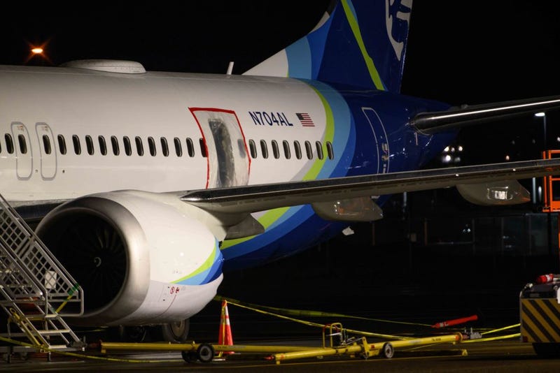 A plastic sheet covers an area of the fuselage of the Alaska Airlines N704AL Boeing 737 MAX 9 aircraft following a midair fuselage blowout on Friday, January 5.