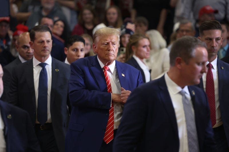 Republican presidential candidate former President Donald Trump greets guests as he wraps up a rally at Clinton Middle School on January 06, 2024 in Clinton, Iowa. 