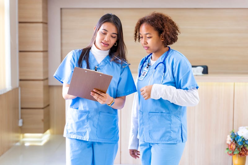 Team of diversity doctor and nurse is discussing and brainstorming on patient medical record after diagnosis for precise care plan with experienced physician specialist