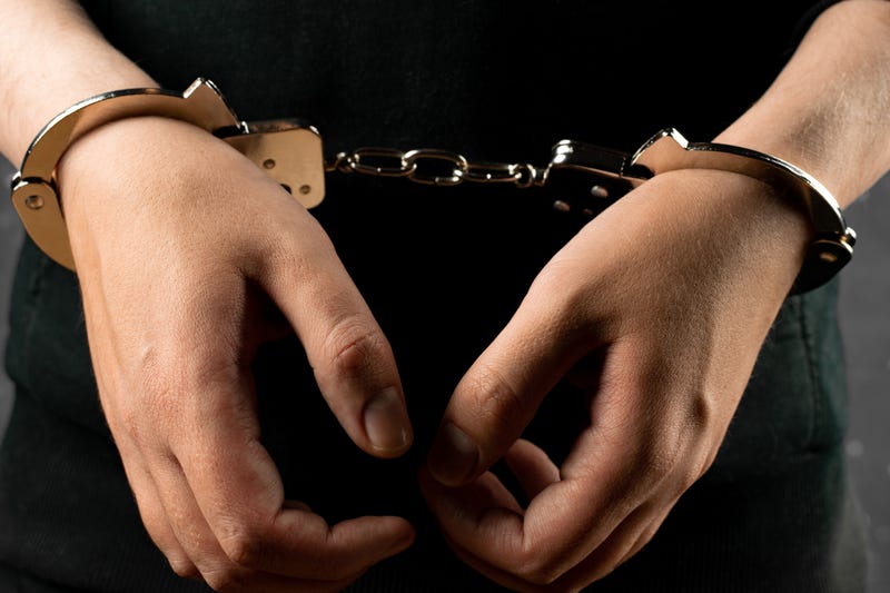 Women's hands in handcuffs