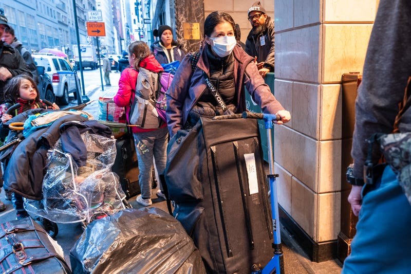 Migrants and their families check into a processing center at the Roosevelt Hotel in Midtown Manhattan on Jan. 9, 2024