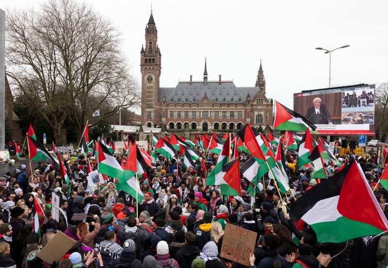 Pro-Palestinian protesters watch the court proceedings on a large TV screen in front of the International Court of Justice on Jan. 12, 2024, in The Hague, Netherlands.