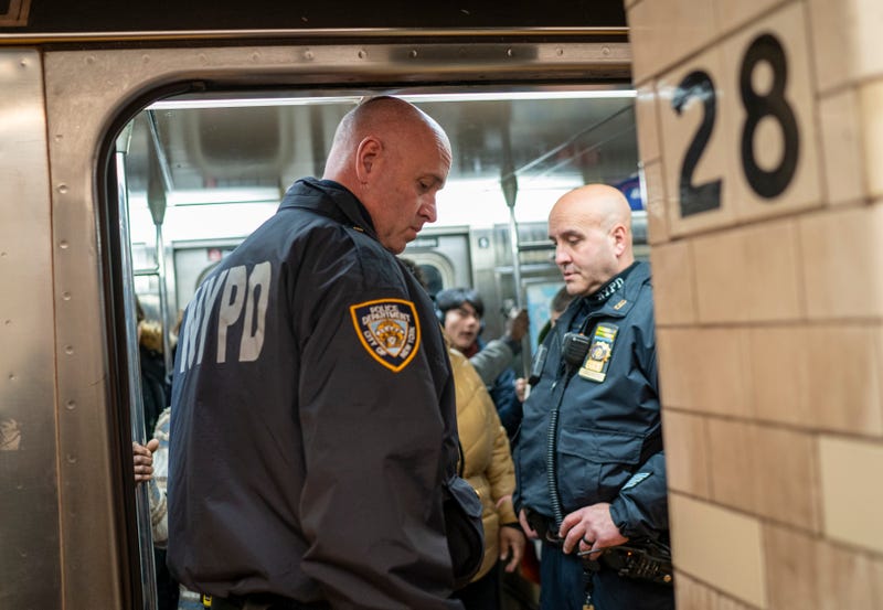 Two NYPD officers ride the subway in Manhattan on January 13, 2024