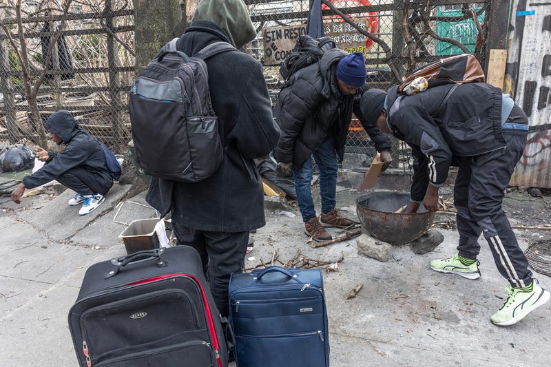 Newly arrived migrants from West Africa cook a meal on the street on January 14, 2024 in Bedford-Stuyvesant, Brooklyn