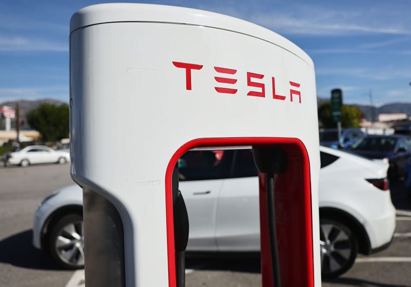 A Tesla electric car pulls up to recharge at a Tesla Supercharger station on January 16, 2024 in Burbank, California.