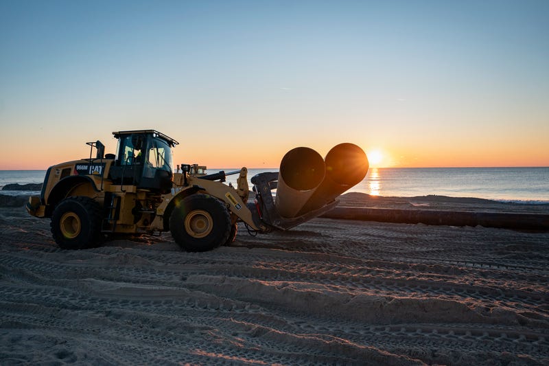 Pipes are moved onto the beach during a nourishment project on Jan. 20, 2024, in Wrightsville Beach, North Carolina.