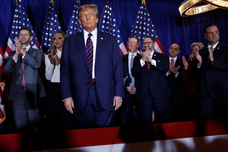 Republican presidential candidate and former U.S. President Donald Trump (C) takes the stage with supporters, campaign staff and family members for a primary night party at the Sheraton on January 23, 2024 in Nashua, New Hampshire. 