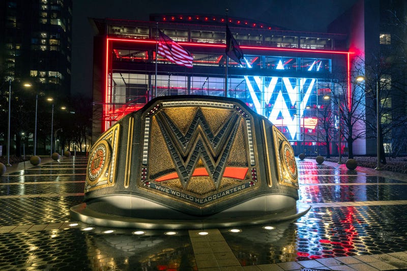 A sculpture of a wrestling belt stands in front of the WWE wrestling world headquarters