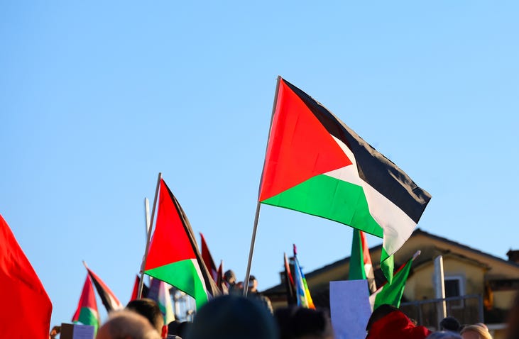 Palestinian flag flying in a stock photo. 