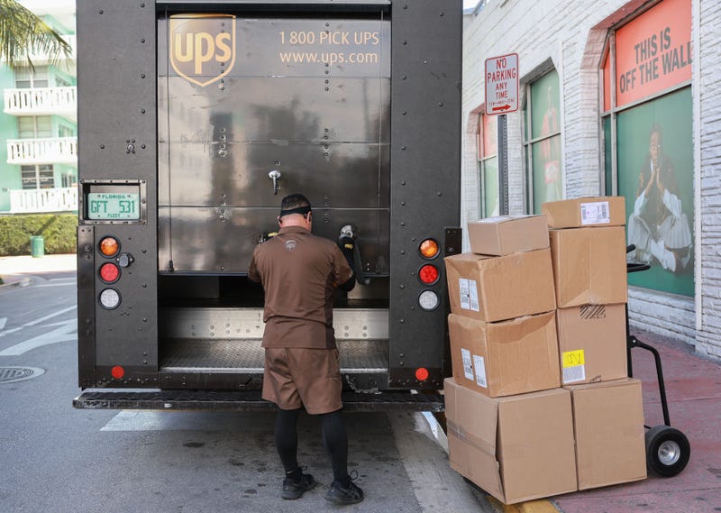 A UPS driver makes a delivery on January 30, 2024 in Miami Beach, Florida. The UPS company announced that it will cut 12,000 jobs as part of a bid to save $1 billion in costs. Managers and contractor positions are reported to be what will make up most of the layoffs.