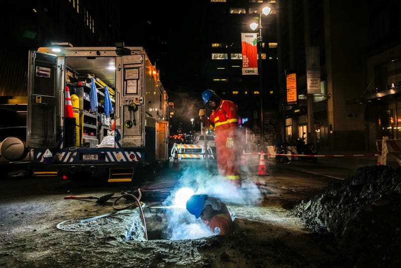 A Con Edison worker works on a steam pipe underground in a street of New York on Feb. 3, 2024.